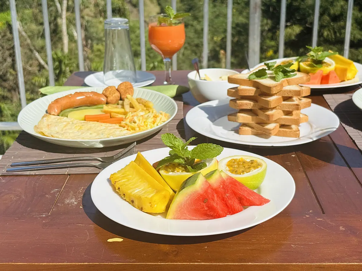 Breakfast on the deck: fruit plates, toast, sausages and fresh juice