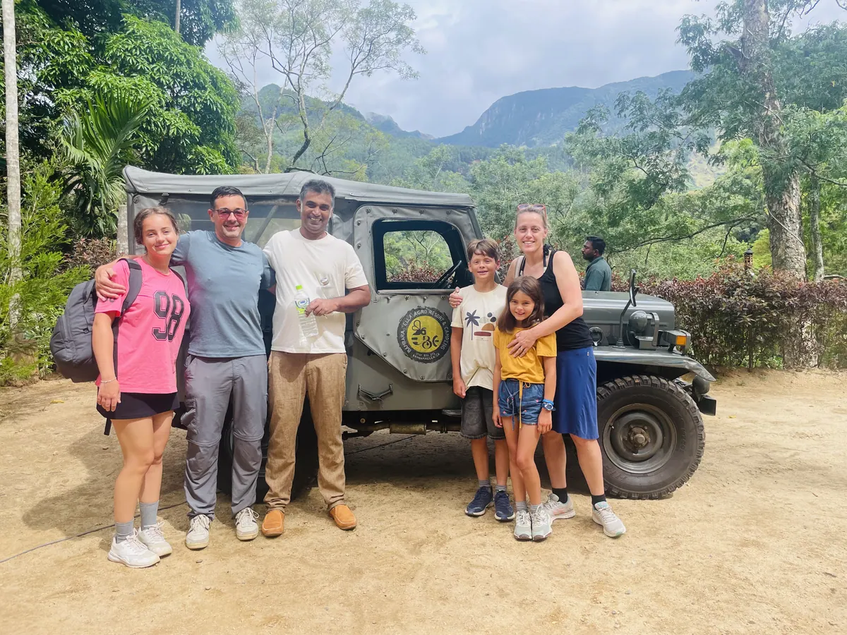 Guests in front of the jeep, the Bambara Ella logo on its door and the hills beyond